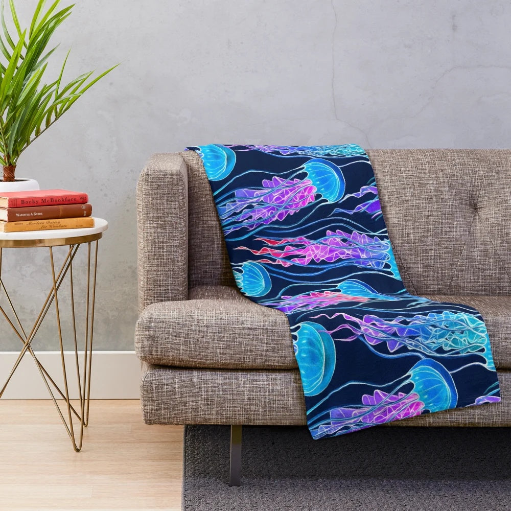 Glowing jellyfish design on a plush navy blue blanket
