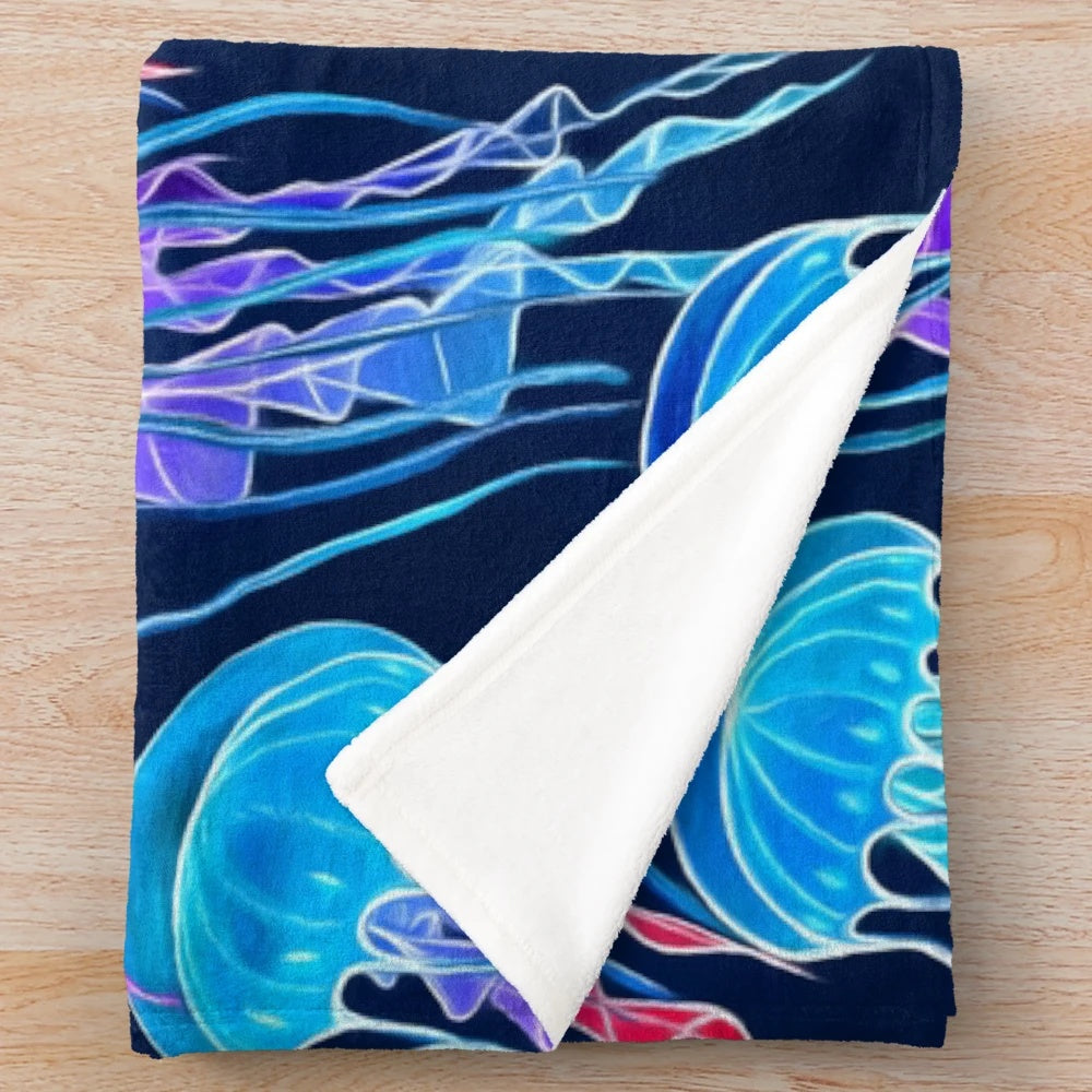 Glowing jellyfish design on a plush navy blue blanket