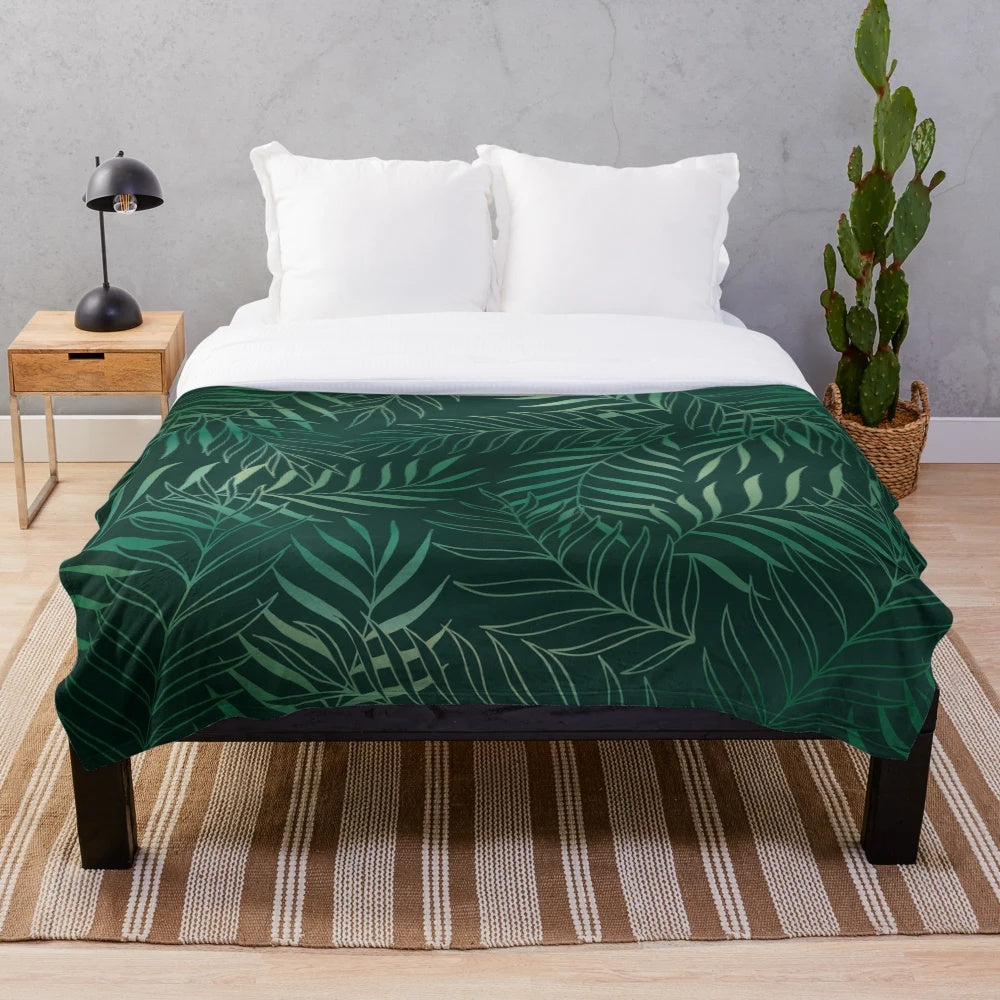 Dark green plush blanket with foliage pattern