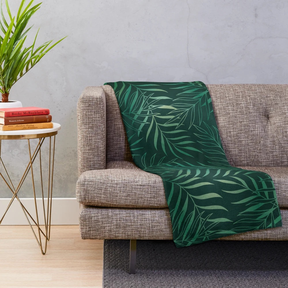 Dark green plush blanket with foliage pattern