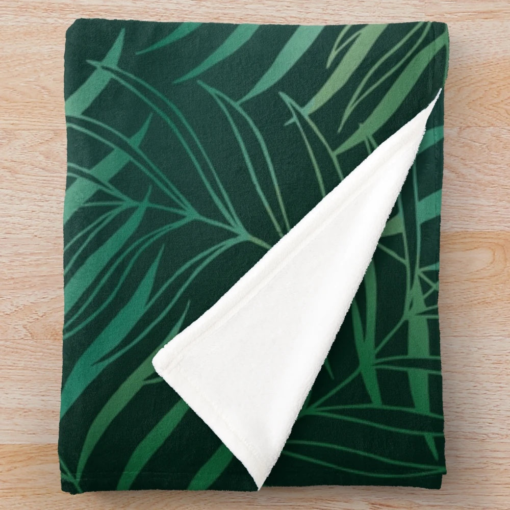 Dark green plush blanket with foliage pattern