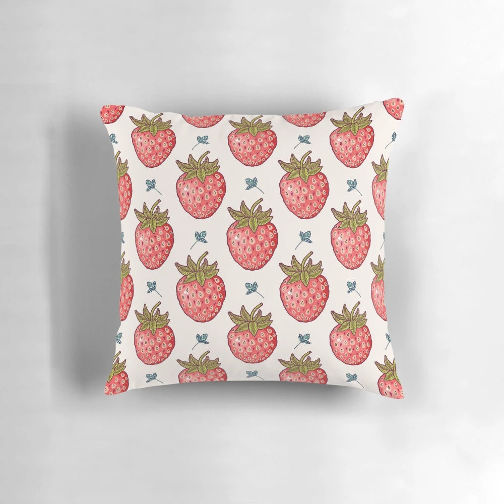 Vibrant strawberry-patterned pillow with lush leaves and pastel accents