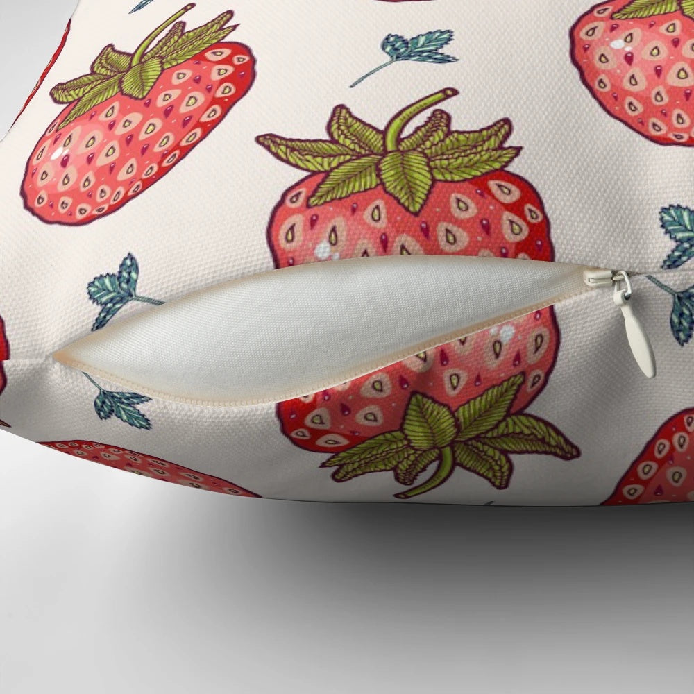 Vibrant strawberry-patterned pillow with lush leaves and pastel accents