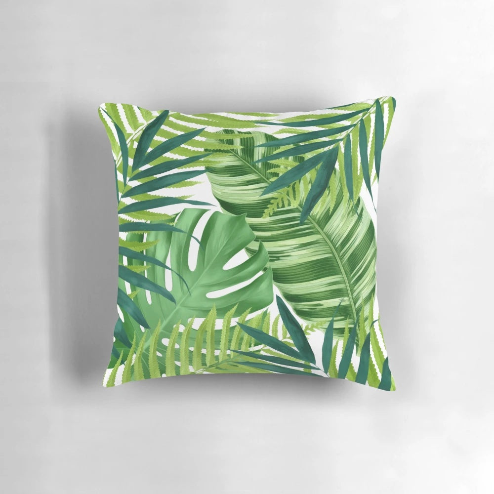 A colorful watercolor-style pillow featuring a pattern of lush, vibrant tropical leaves and foliage.