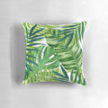 A colorful watercolor-style pillow featuring a pattern of lush, vibrant tropical leaves and foliage.