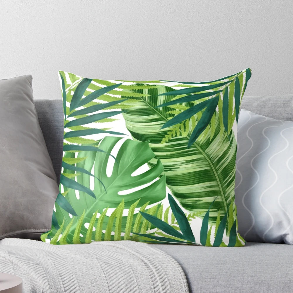 A colorful watercolor-style pillow featuring a pattern of lush, vibrant tropical leaves and foliage.