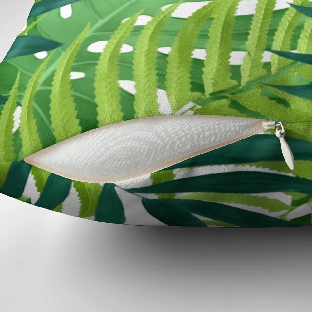 A colorful watercolor-style pillow featuring a pattern of lush, vibrant tropical leaves and foliage.