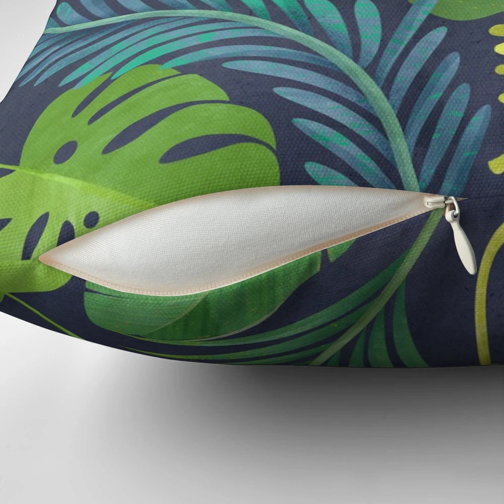 Tropical rainforest-inspired pillow featuring a vibrant botanical pattern with palm trees and banana leaves.