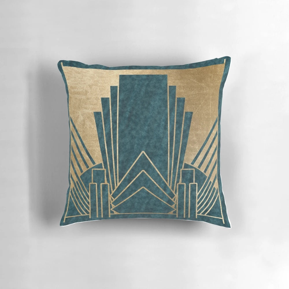 Teal and gold art deco inspired decorative pillow with geometric patterns and a luxurious texture.