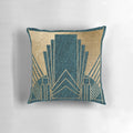 Teal and gold art deco inspired decorative pillow with geometric patterns and a luxurious texture.