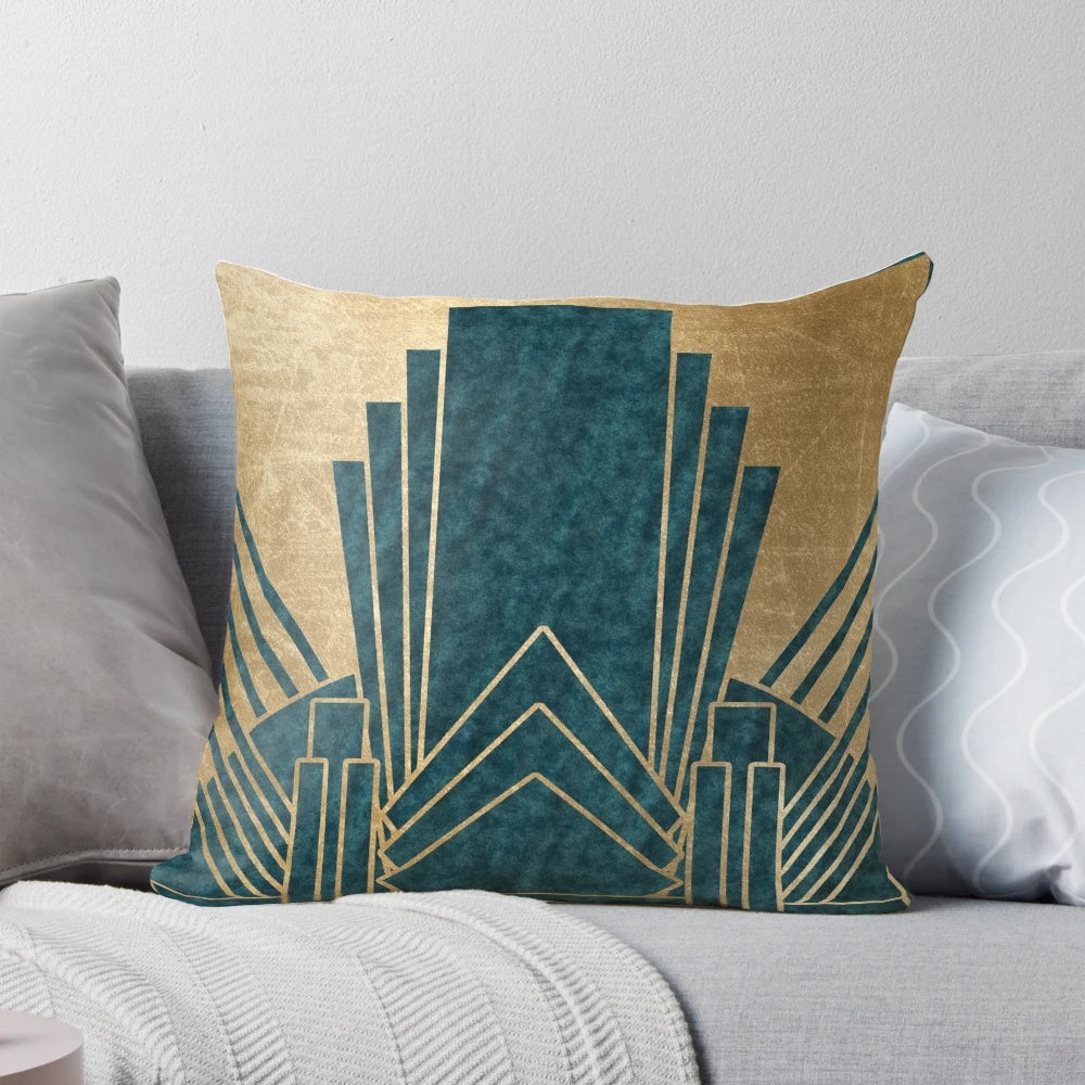 Teal and gold art deco inspired decorative pillow with geometric patterns and a luxurious texture.