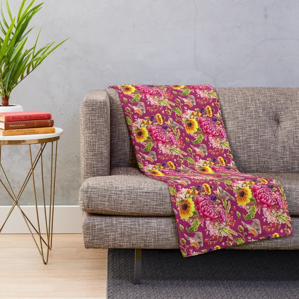Soft and plush autumn-inspired blanket with jewel tones and nature motifs