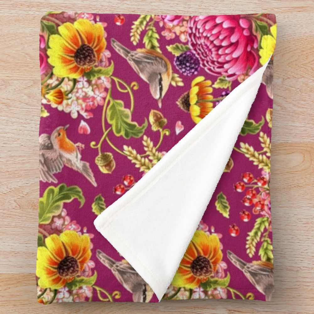 Soft and plush autumn-inspired blanket with jewel tones and nature motifs