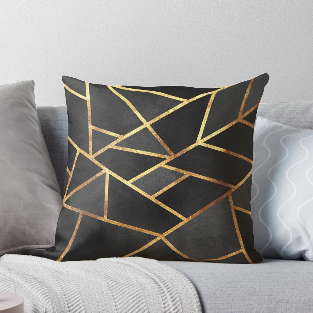 Black and gold geometric pillow with abstract marble pattern design