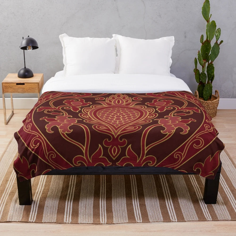 Burgundy plush blanket folded on a couch