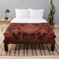 Burgundy plush blanket folded on a couch