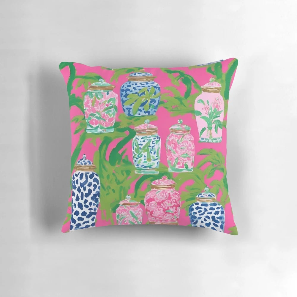 Stylish chinoiserie ginger jars and tropical banana leaves printed on a hot pink decorative pillow