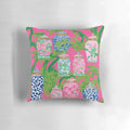 Stylish chinoiserie ginger jars and tropical banana leaves printed on a hot pink decorative pillow