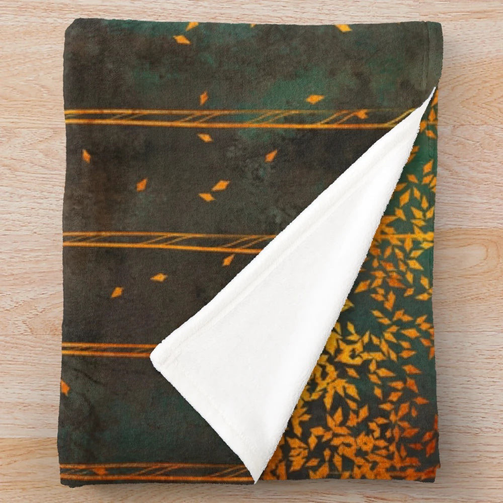 Closeup of a metallic copper plush blanket with botanical birch tree print