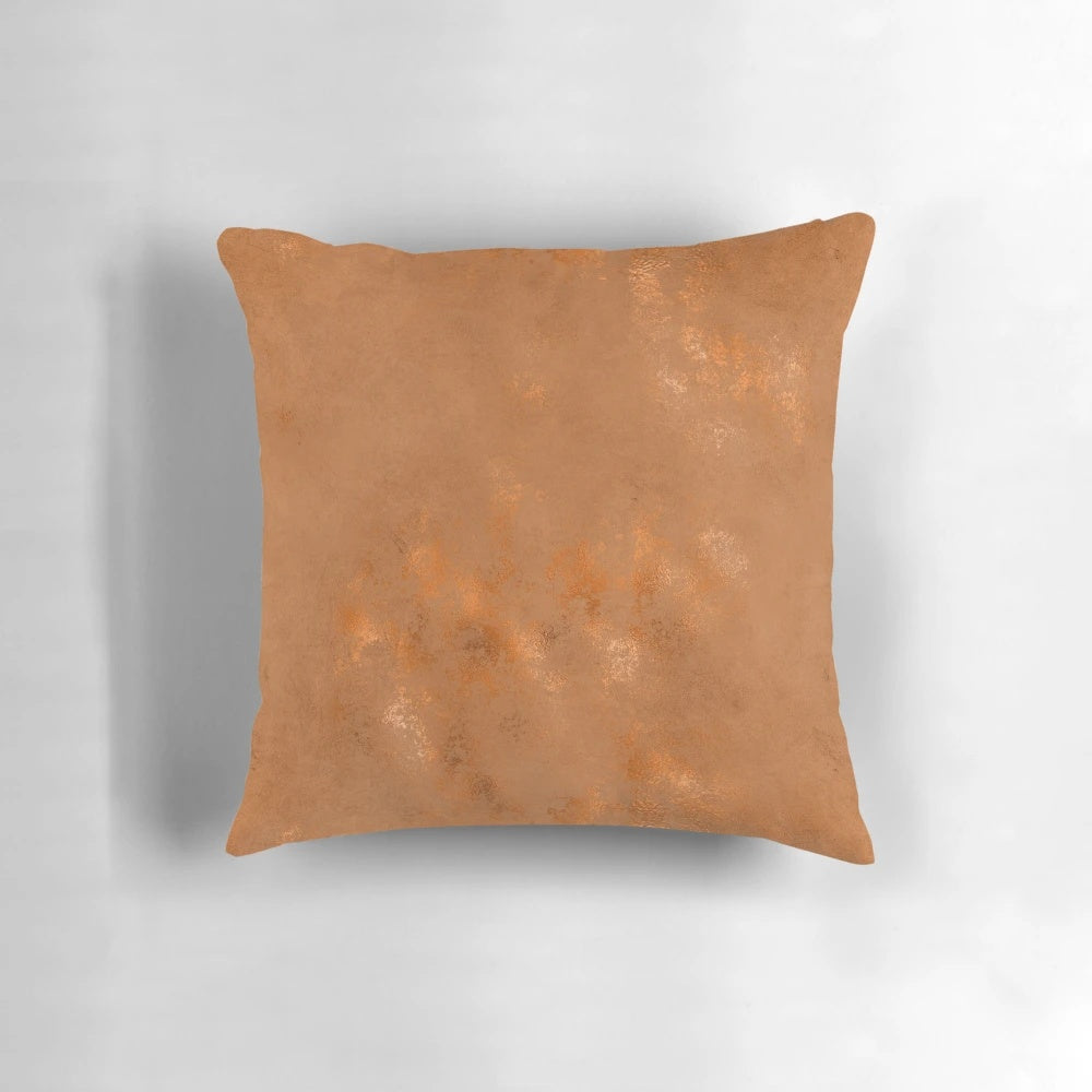 Closeup of a black and white geometric pattern pillow with metallic copper accents