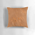 Closeup of a black and white geometric pattern pillow with metallic copper accents