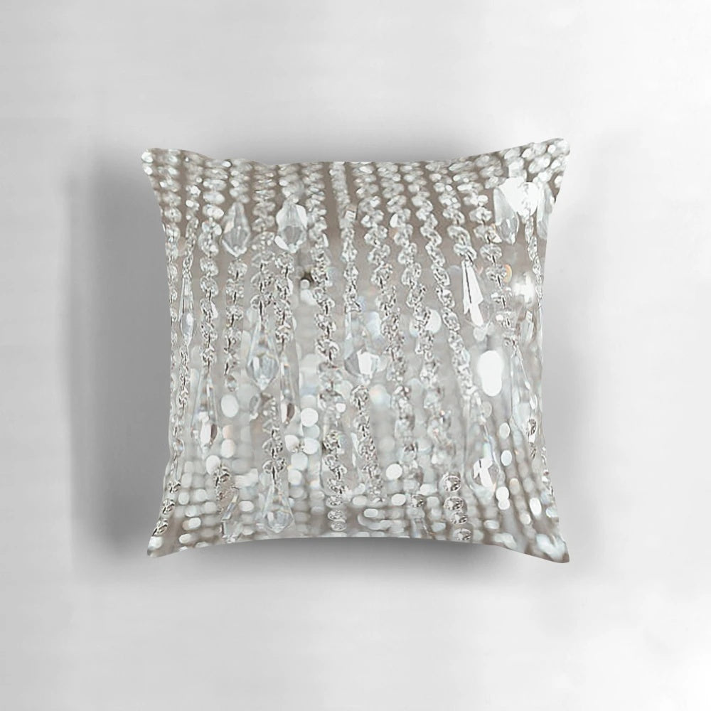 A decorative pillow featuring a photographic image of a crystal chandelier with brilliant lights.