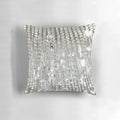 A decorative pillow featuring a photographic image of a crystal chandelier with brilliant lights.