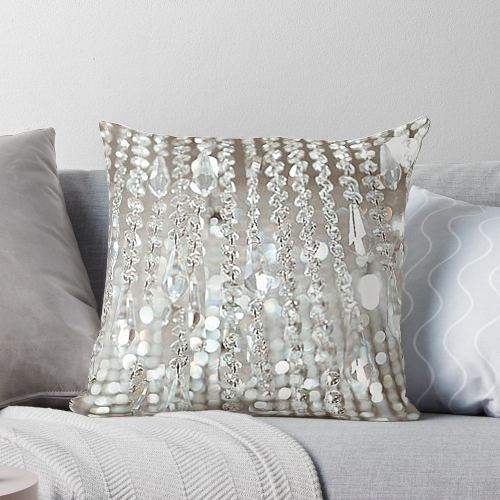 A decorative pillow featuring a photographic image of a crystal chandelier with brilliant lights.