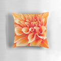 Vibrant orange dahlia flower pillow with ruffled and swirling design