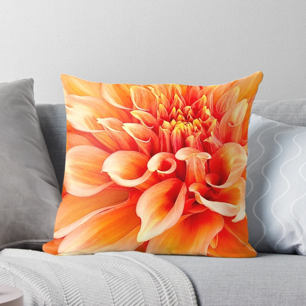 Vibrant orange dahlia flower pillow with ruffled and swirling design