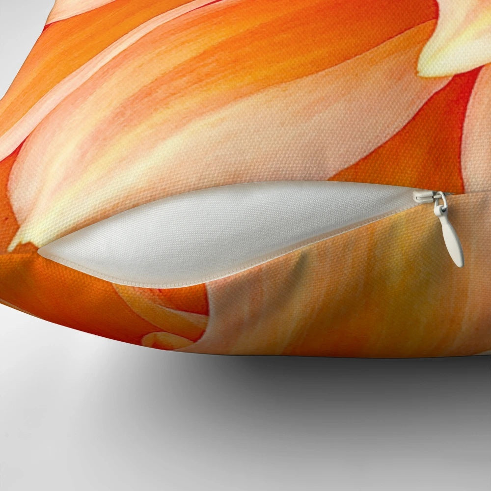 Vibrant orange dahlia flower pillow with ruffled and swirling design