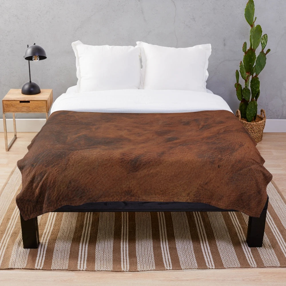 Dark plush blanket with a leather-like patterned design