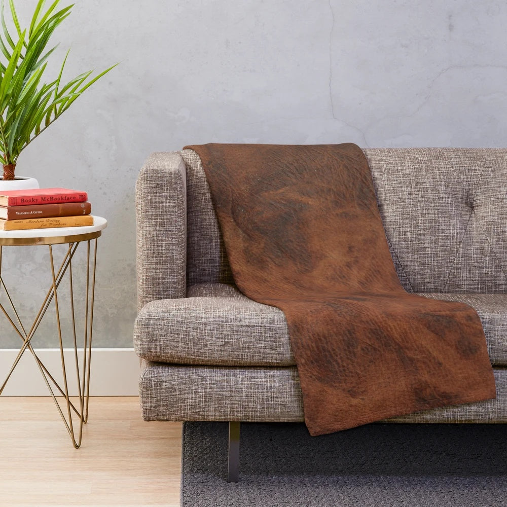 Dark plush blanket with a leather-like patterned design