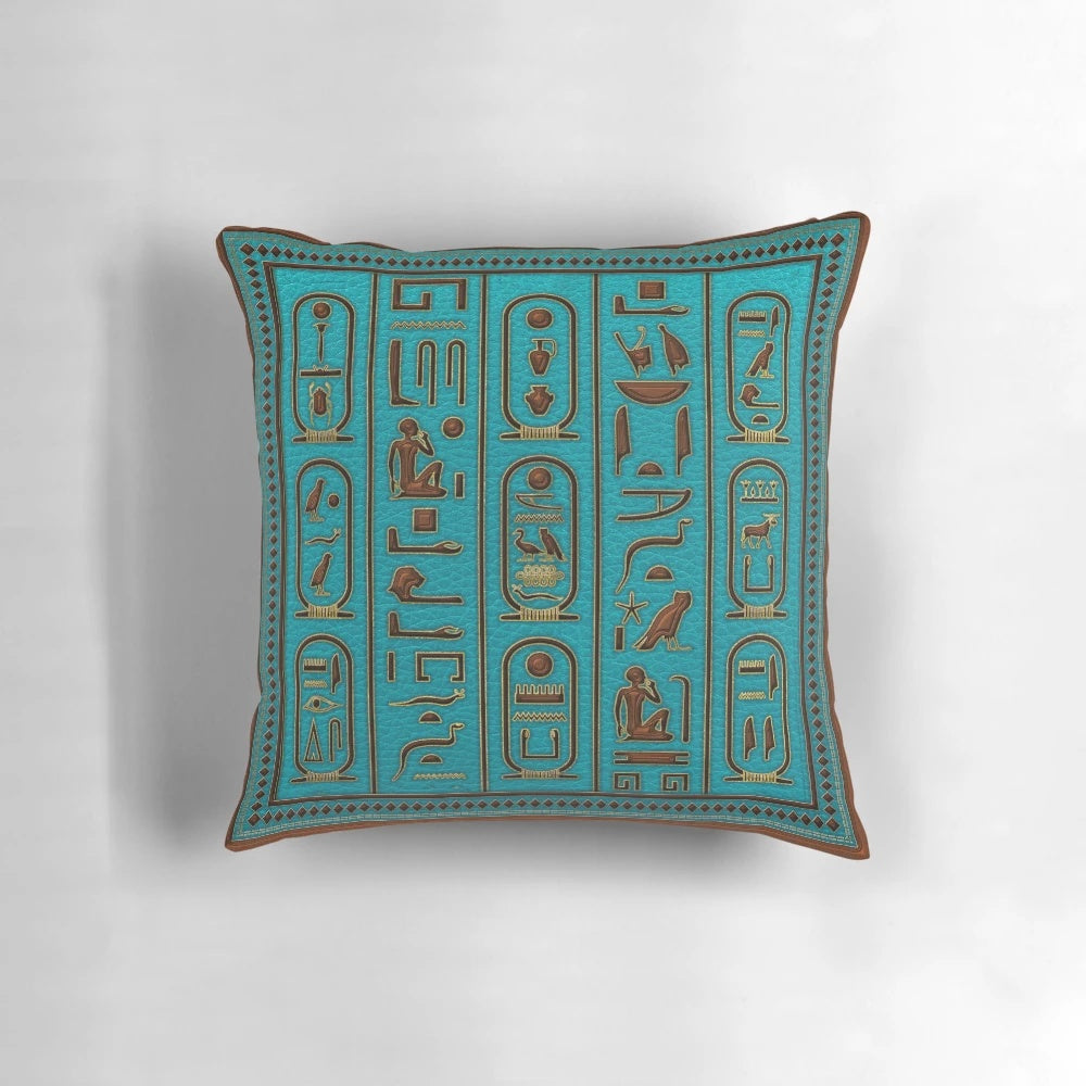 Decorative Egyptian leather pillow with gold hieroglyphic embossing on a teal background