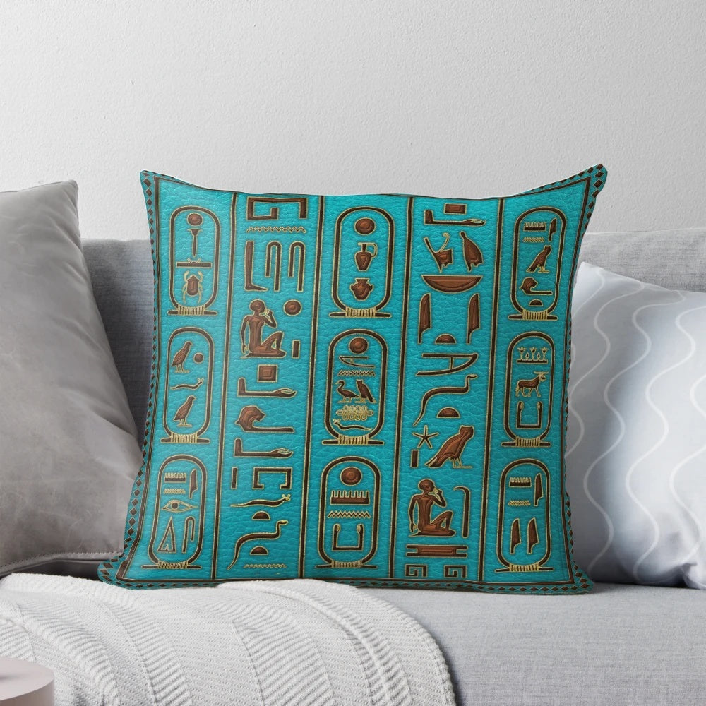 Decorative Egyptian leather pillow with gold hieroglyphic embossing on a teal background