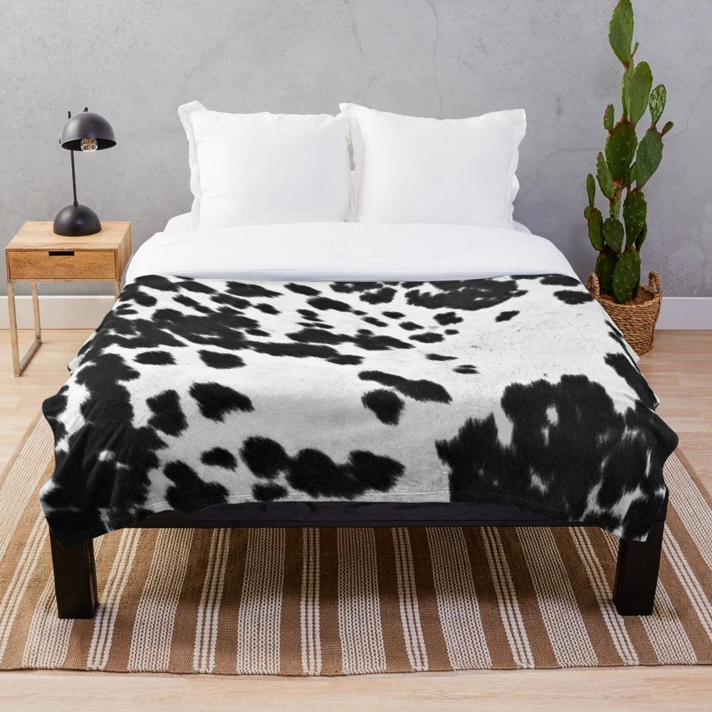 Faux cowhide black and white plush blanket for cozy home decor