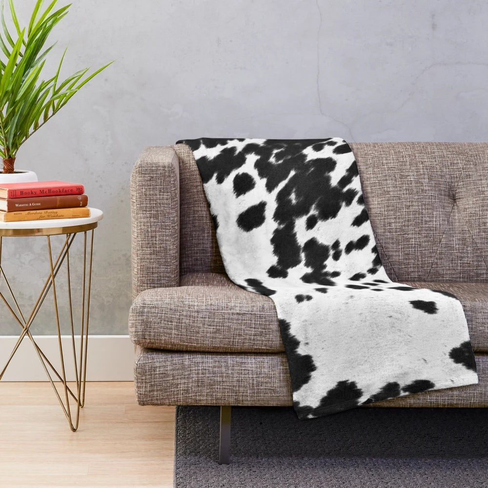 Faux cowhide black and white plush blanket for cozy home decor
