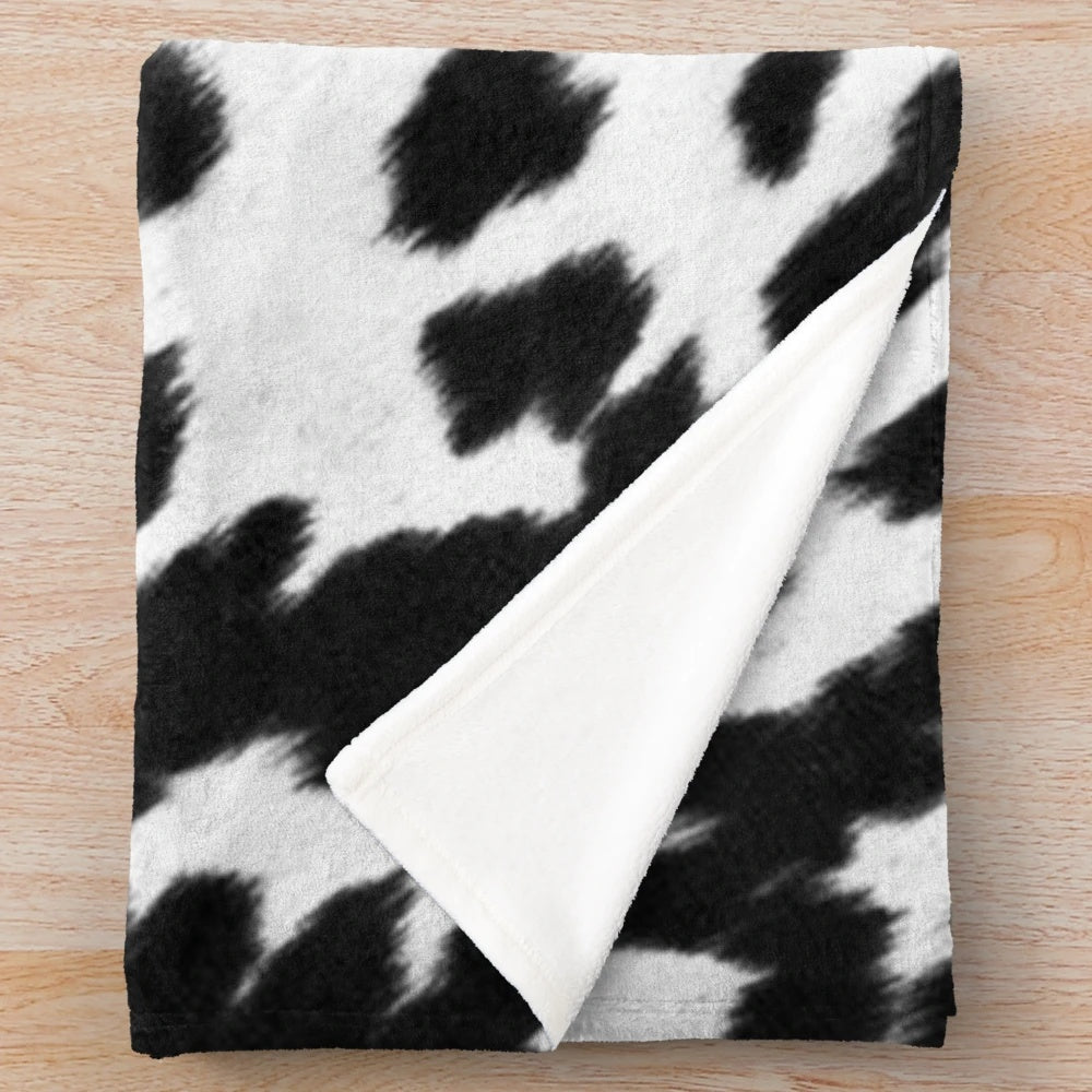 Faux cowhide black and white plush blanket for cozy home decor