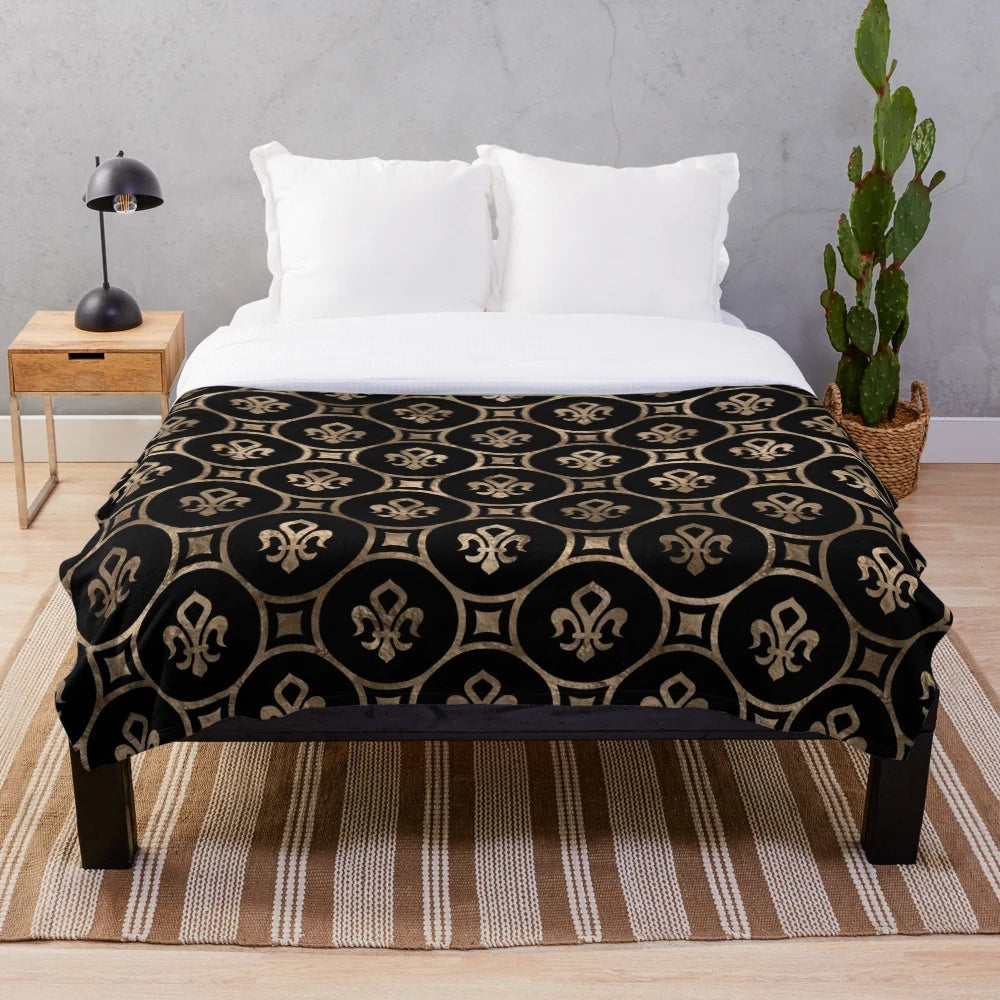 Black and gold plush blanket with a fleur-de-lis pattern