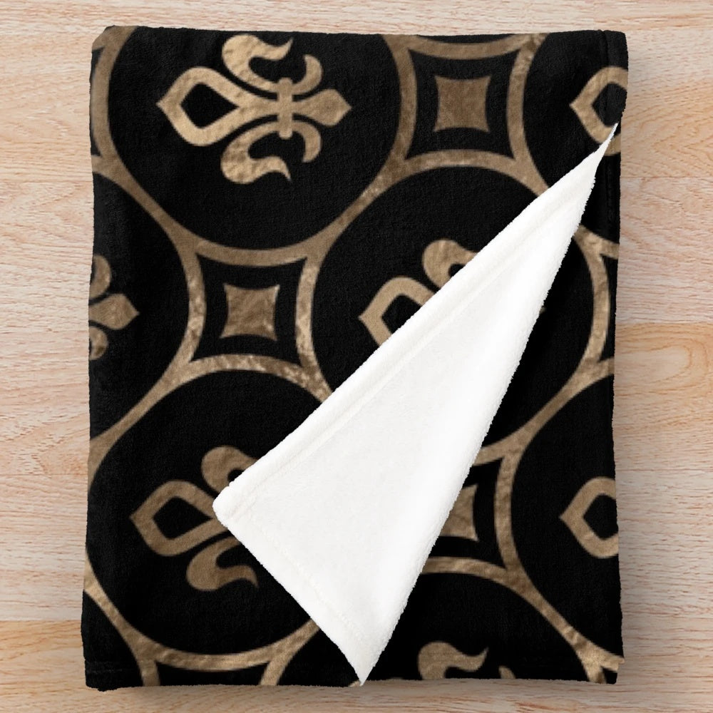 Black and gold plush blanket with a fleur-de-lis pattern