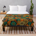 Plush floral blanket in teal and orange colors