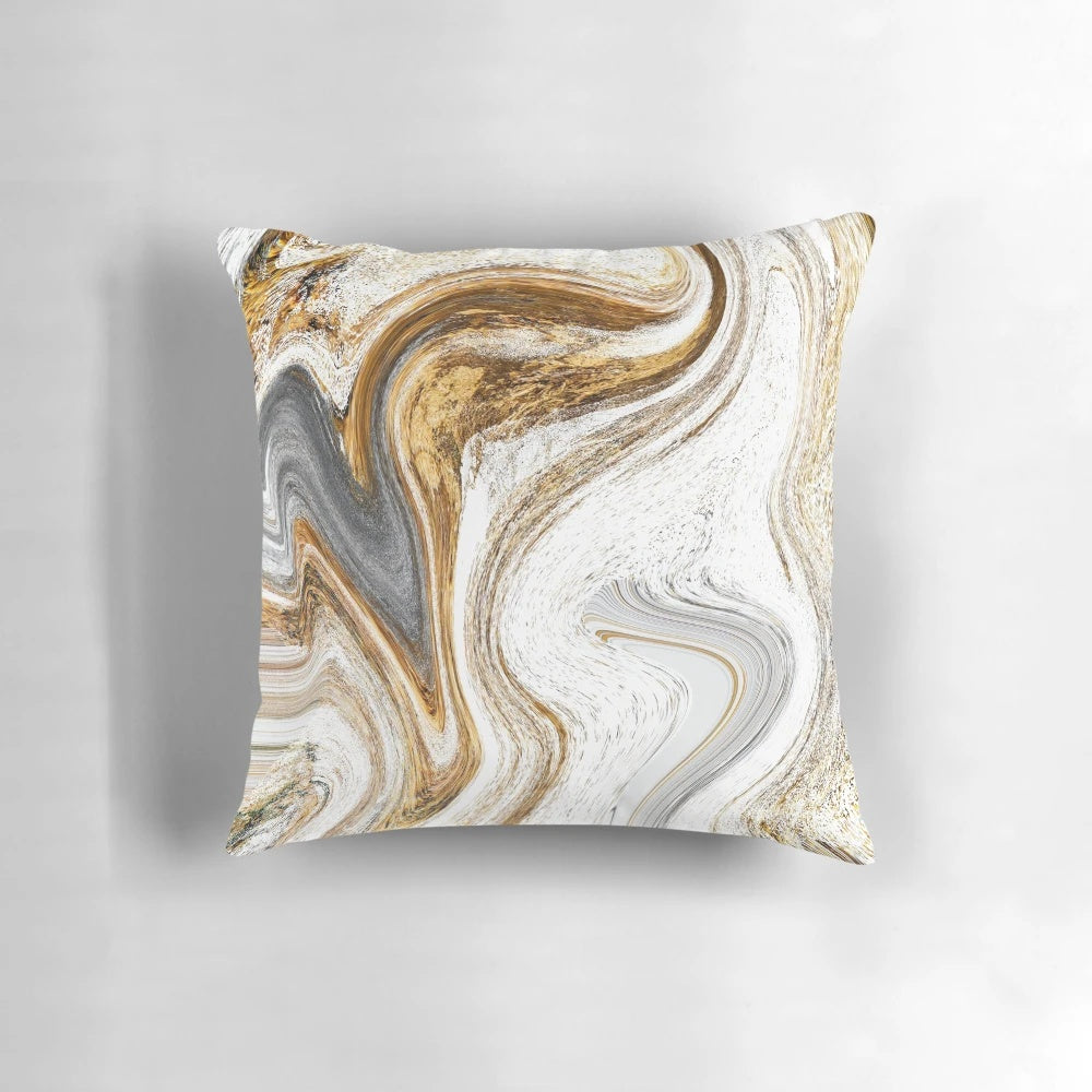 A white and gold luxury pillow with a fluid ink and liquid marble pattern.