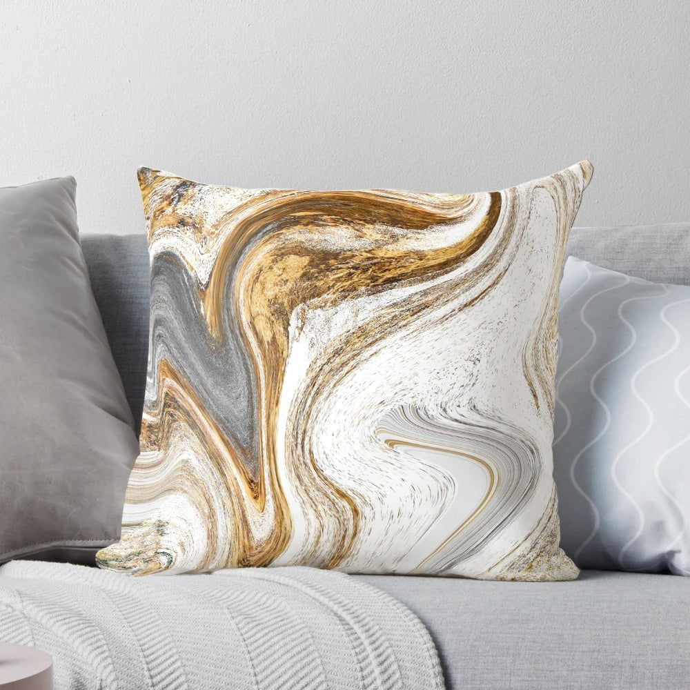 A white and gold luxury pillow with a fluid ink and liquid marble pattern.