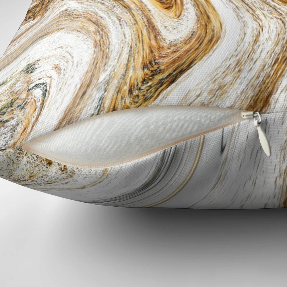 A white and gold luxury pillow with a fluid ink and liquid marble pattern.
