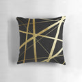 Closeup of a geometric patterned black and gold decorative pillow