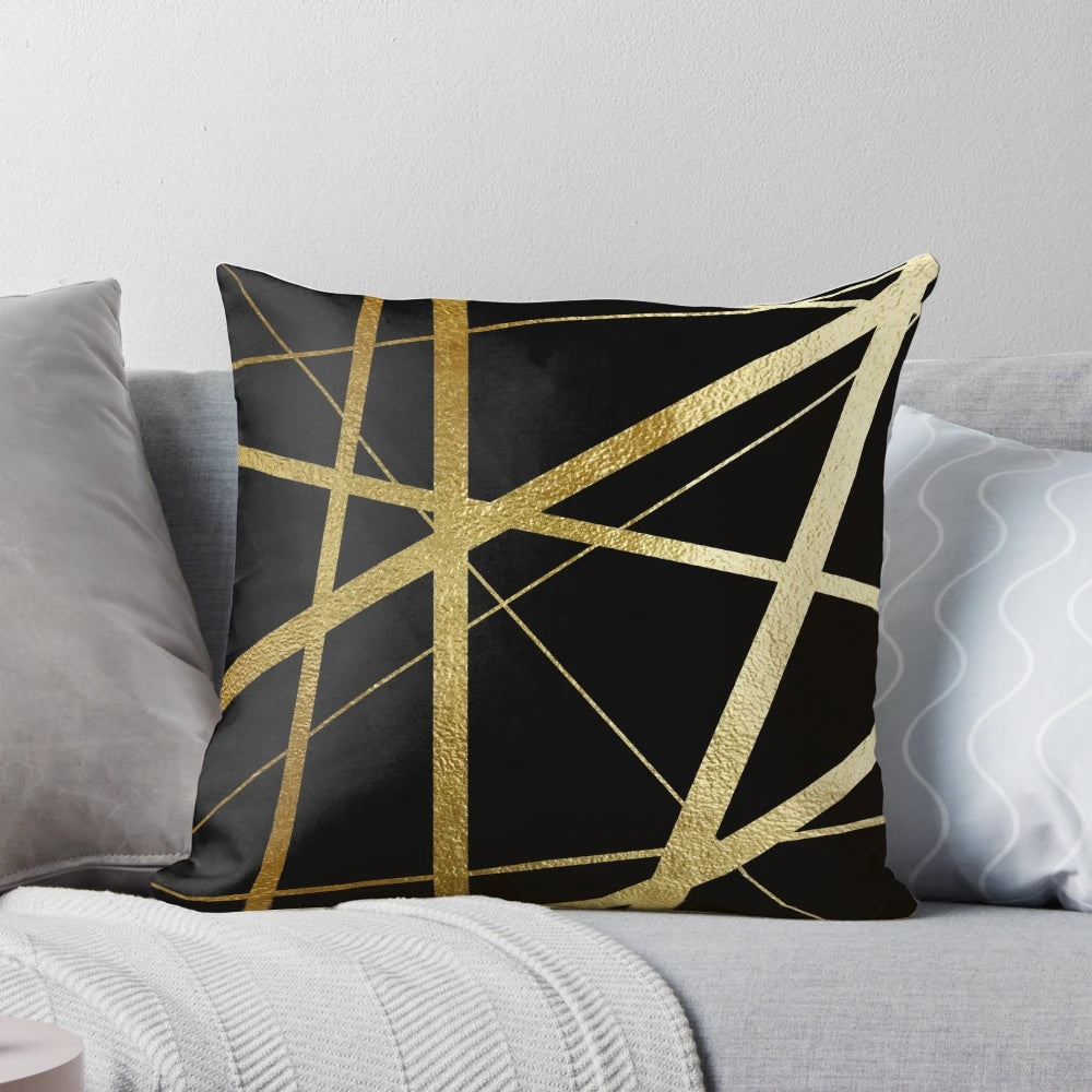 Closeup of a geometric patterned black and gold decorative pillow