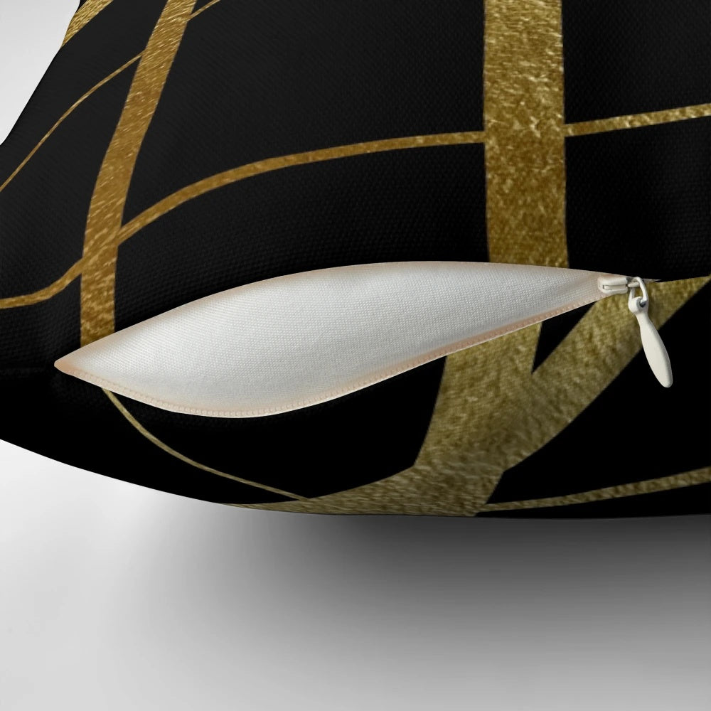 Closeup of a geometric patterned black and gold decorative pillow