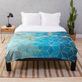 Plush blue and gold geometric cube pattern blanket