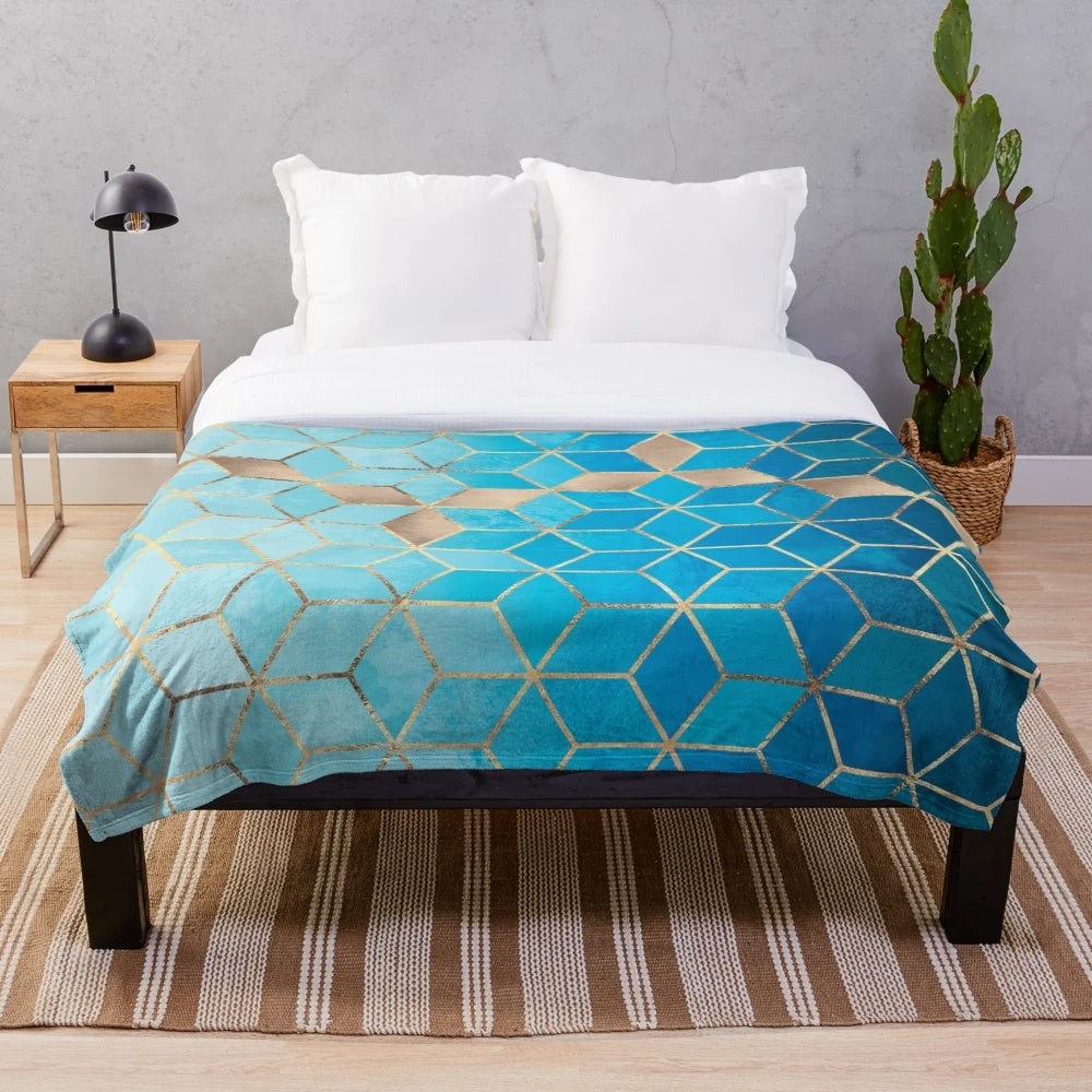 Plush blue and gold geometric cube pattern blanket