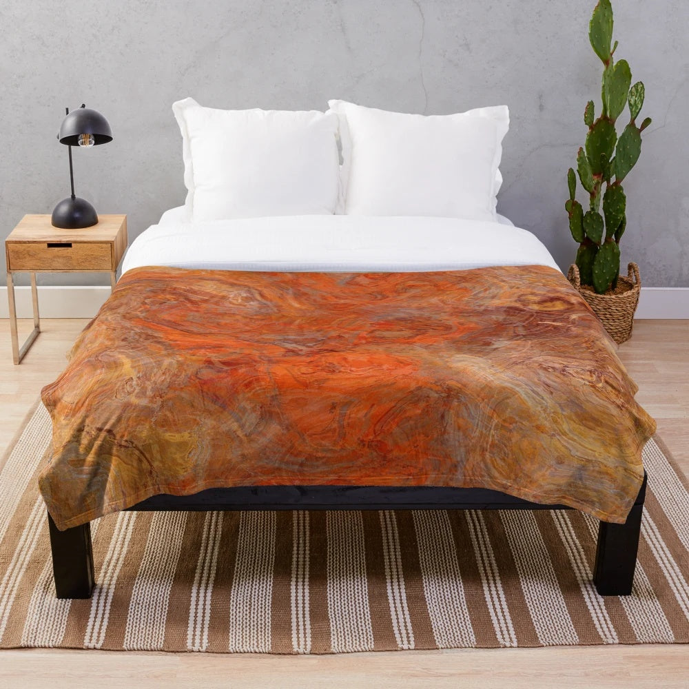 Gold and rust swirl pattern on a cozy plush blanket